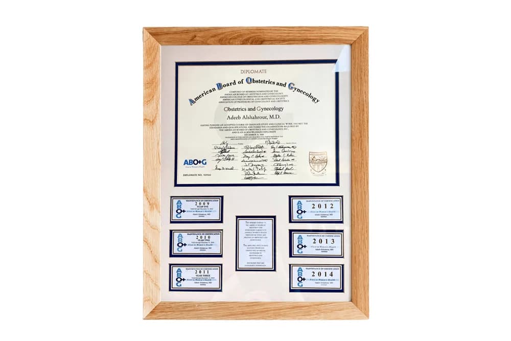Framed American Board of Obstetrics and Gynecology diplomate certificate issued to Adeeb Alshahrour, MD, with maintenance-of-certification plaques for 2009 through 2014